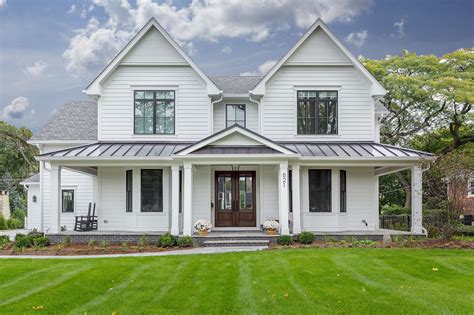 white ranch house with black metal roof|black roofed farmhouse exterior.